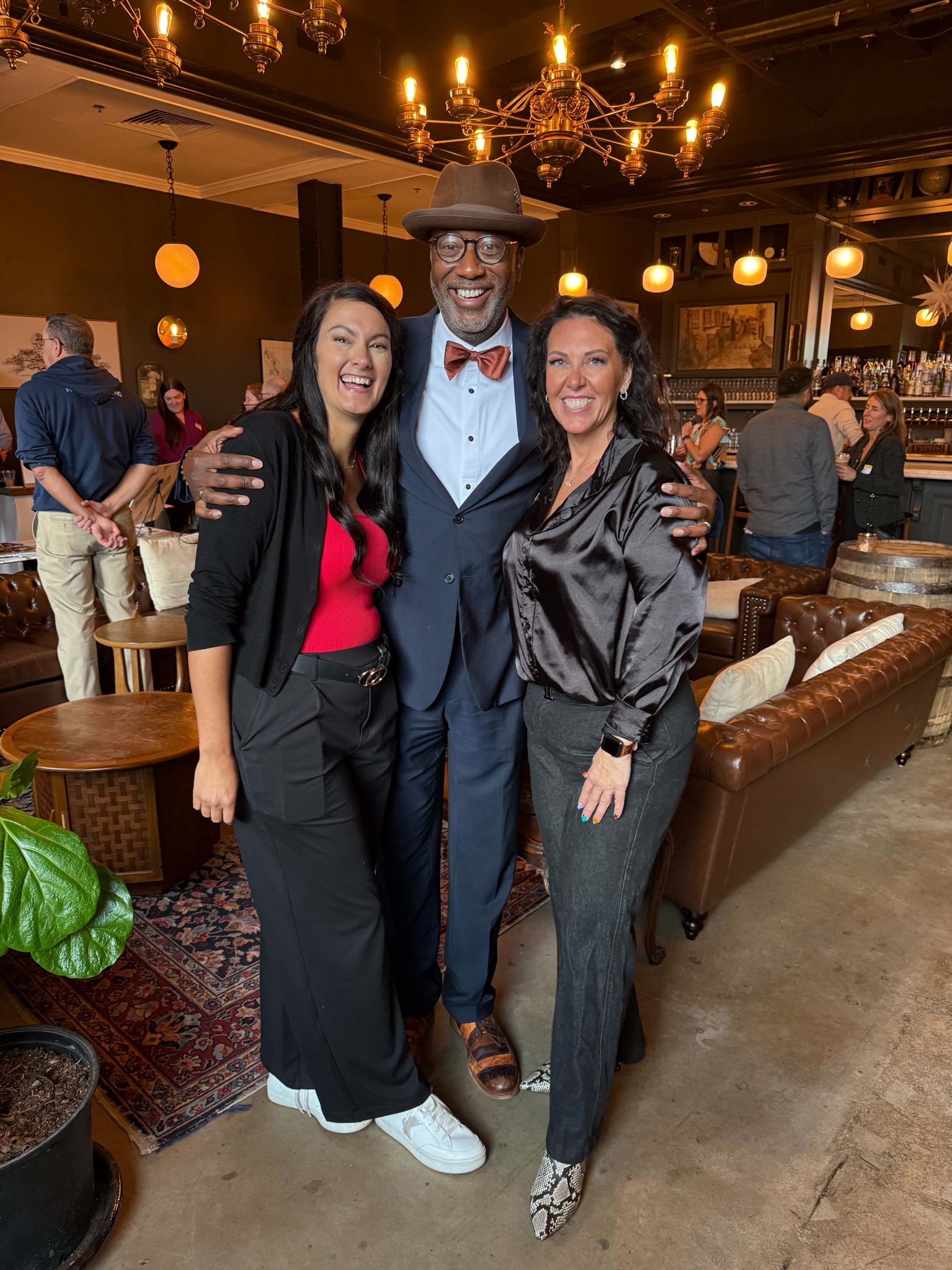 Sarah Gilliam, Dr. David Banks, and Kelly Harple together at Fifty Fifty Wine and Martini Bar